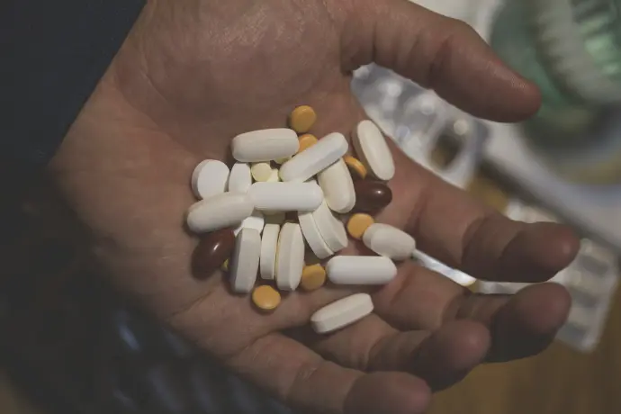 white oval medication pill on persons hand